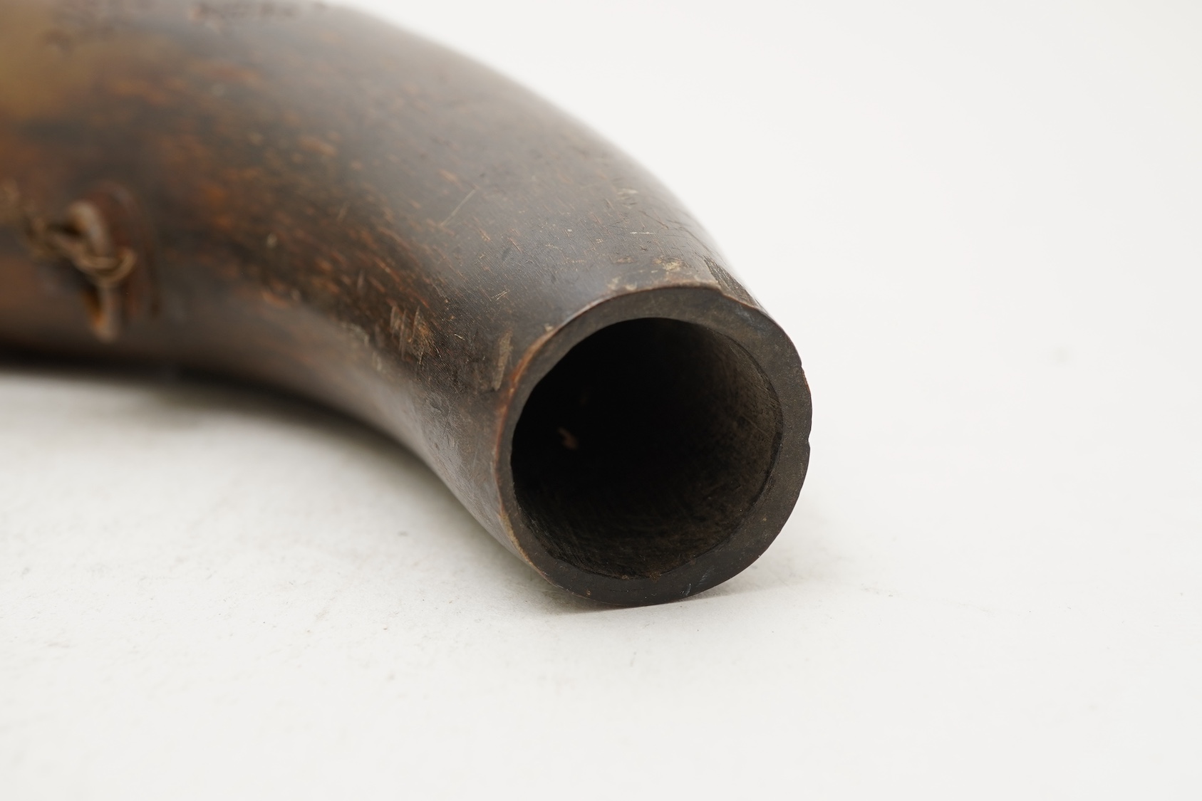 A Tibetan or Mongolian inscribed buffalo horn powder flask, 18th century